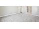 Neutral toned room showcases carpeted floors and leads to a bright hallway at 5909 S Platte Canyon Dr, Littleton, CO 80123
