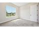 Serene bedroom featuring a large window with a view and neutral-toned carpet at 5909 S Platte Canyon Dr, Littleton, CO 80123