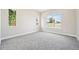 A bright bedroom featuring carpet, neutral walls, and ample windows at 5909 S Platte Canyon Dr, Littleton, CO 80123