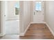 Bright entryway with wood floors, leading to a carpeted room with natural light at 5909 S Platte Canyon Dr, Littleton, CO 80123