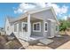 Single-Gathering home exterior with covered patio and gray siding at 5909 S Platte Canyon Dr, Littleton, CO 80123