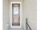 Elegant front door with glass inserts, providing natural light and enhancing the home's entryway at 5909 S Platte Canyon Dr, Littleton, CO 80123