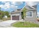 Beautifully designed home featuring a garage, a pristine lawn, and a welcoming facade at 5909 S Platte Canyon Dr, Littleton, CO 80123