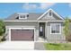Charming home featuring an attached garage, a manicured lawn, and a classic exterior design at 5909 S Platte Canyon Dr, Littleton, CO 80123