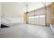 Bright and spacious two-car garage with concrete flooring, offering ample space for parking and storage at 5909 S Platte Canyon Dr, Littleton, CO 80123