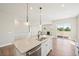 Contemporary kitchen island with sleek countertops and a view of the open living area at 5909 S Platte Canyon Dr, Littleton, CO 80123