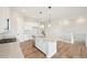Open concept kitchen with a spacious island and modern lighting fixtures at 5909 S Platte Canyon Dr, Littleton, CO 80123