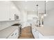 Bright kitchen with white cabinets, stainless appliances, and a large island at 5909 S Platte Canyon Dr, Littleton, CO 80123