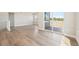 Open-concept living room with wood floors, large windows, and natural light at 5909 S Platte Canyon Dr, Littleton, CO 80123