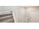 Carpeted stairs with white railing leading to the upper level of the home at 5909 S Platte Canyon Dr, Littleton, CO 80123