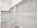 Bright walk-in closet with ample shelf storage and carpet flooring at 5909 S Platte Canyon Dr, Littleton, CO 80123