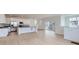 Bright, open-concept living space with hardwood floors, white walls, modern lighting, and sliding glass door to a deck at 2094 S Haleyville Way, Aurora, CO 80018