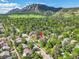 Breathtaking aerial view of a home surrounded by nature, mountains, and a charming neighborhood at 1029 9Th St, Boulder, CO 80302