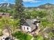 Charming home with a red door, nestled among lush greenery and stunning mountain views at 1029 9Th St, Boulder, CO 80302