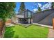 Landscaped backyard with a modern patio, lush green lawn, and stylish exterior at 1029 9Th St, Boulder, CO 80302