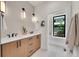 Modern bathroom boasts double sinks, wood cabinetry, and a large window at 1029 9Th St, Boulder, CO 80302