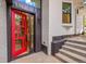 Stunning entryway with a modern red door, brick exterior, and updated design at 1029 9Th St, Boulder, CO 80302