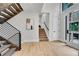 Entryway with wood stairs, modern railings, and a view of the main level's open layout at 1029 9Th St, Boulder, CO 80302