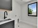 Functional laundry room with gray cabinets, stainless steel sink, and natural light at 1029 9Th St, Boulder, CO 80302