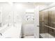 Bright bathroom with double vanity, large mirror, and glass enclosed shower at 22415 E 7Th Pl, Aurora, CO 80018
