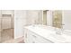 Bright bathroom with dual sinks, white cabinets and a walk-in shower at 22415 E 7Th Pl, Aurora, CO 80018