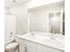 Bathroom featuring a double vanity, tiled tub, and toilet at 22415 E 7Th Pl, Aurora, CO 80018