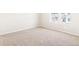 Neutral carpeted bedroom with white walls and two windows at 22415 E 7Th Pl, Aurora, CO 80018