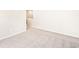 A spacious, neutral bedroom with carpet and a view into a hallway at 22415 E 7Th Pl, Aurora, CO 80018
