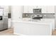 Kitchen features a large island, stainless appliances, and a stylish backsplash at 22415 E 7Th Pl, Aurora, CO 80018