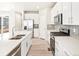 Modern kitchen features stainless appliances and stylish gray backsplash at 22415 E 7Th Pl, Aurora, CO 80018