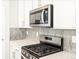 Updated kitchen with stainless steel appliances and stylish backsplash at 22415 E 7Th Pl, Aurora, CO 80018