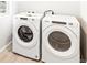 Modern laundry room features a white front-load washer and dryer at 22415 E 7Th Pl, Aurora, CO 80018