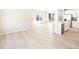 Bright, open-concept living space features hardwood floors, large windows and stainless steel appliances at 22415 E 7Th Pl, Aurora, CO 80018