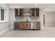 Basement wet bar with wood cabinets, quartz countertops, and wine cooler at 1149 S Madison St, Denver, CO 80210