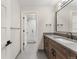 Modern bathroom with gray vanity, a large mirror and a glass shower at 1149 S Madison St, Denver, CO 80210