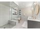 Spa-like bathroom featuring a glass-enclosed shower, soaking tub, and dual vanity sinks at 1149 S Madison St, Denver, CO 80210