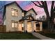 Two-story brick home with a covered porch and landscaped yard at 1149 S Madison St, Denver, CO 80210