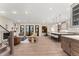 Bright, open-concept living room flows into kitchen, showcasing hardwood floors and modern design at 1149 S Madison St, Denver, CO 80210