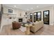 Bright living room boasting a fireplace, hardwood floors, and access to the outdoors through French doors at 1149 S Madison St, Denver, CO 80210