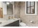 Elegant powder room featuring a marble countertop, designer wallpaper, and stylish fixtures at 1149 S Madison St, Denver, CO 80210