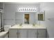 Double vanity bathroom offers great lighting, a toilet, and a view into an adjacent room at 3857 Mossy Rock Dr # 201, Highlands Ranch, CO 80126