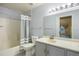Clean bathroom features a shower, toilet, vanity with sink, and light fixtures at 3857 Mossy Rock Dr # 201, Highlands Ranch, CO 80126