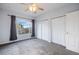 Bedroom offers ample closet space, with a ceiling fan and natural light streaming through a large window at 3857 Mossy Rock Dr # 201, Highlands Ranch, CO 80126