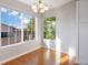Bright dining area featuring hardwood floors, neutral paint, and abundant natural light through large windows at 3857 Mossy Rock Dr # 201, Highlands Ranch, CO 80126