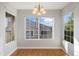 Dining room with hardwood floors, light-colored walls, and large windows, creating a bright and inviting atmosphere at 3857 Mossy Rock Dr # 201, Highlands Ranch, CO 80126