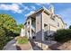 Attractive condo showcasing well-maintained siding, entry stairs, landscaping, and charming curb appeal at 3857 Mossy Rock Dr # 201, Highlands Ranch, CO 80126