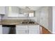 Well-lit kitchen features granite counters, stainless steel appliances, and a double sink with an entryway door at 3857 Mossy Rock Dr # 201, Highlands Ranch, CO 80126