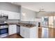 Open-concept living area with a kitchen, stainless steel appliances, and access to outdoor balcony at 3857 Mossy Rock Dr # 201, Highlands Ranch, CO 80126