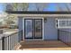 A home's outdoor deck features a wood floor and a door leading to the inside at 11506 Fowler Dr, Northglenn, CO 80233