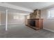 Spacious basement featuring a brick fireplace and neutral carpeting at 11506 Fowler Dr, Northglenn, CO 80233